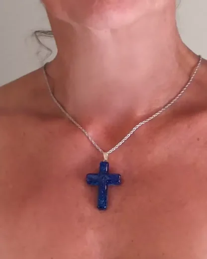 large blue Murano glass cross being worn on model