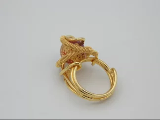 intricate gold rhodiium metal ring with red and gold Venetian bead