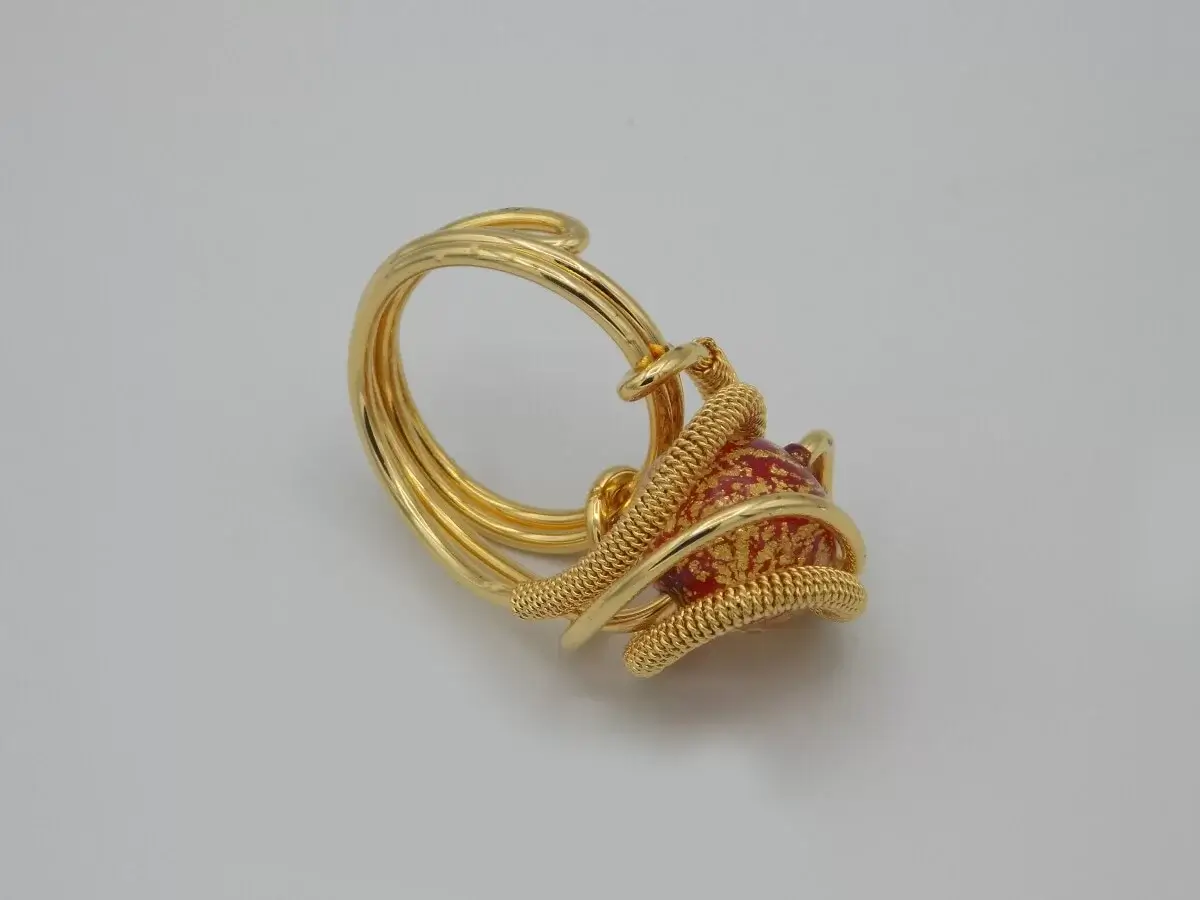 gold rhodium swirling metal ring with red and gold Venetian glass bead