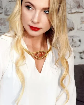 close up of model with golden multi-strand collar necklace with red Murano glass beads