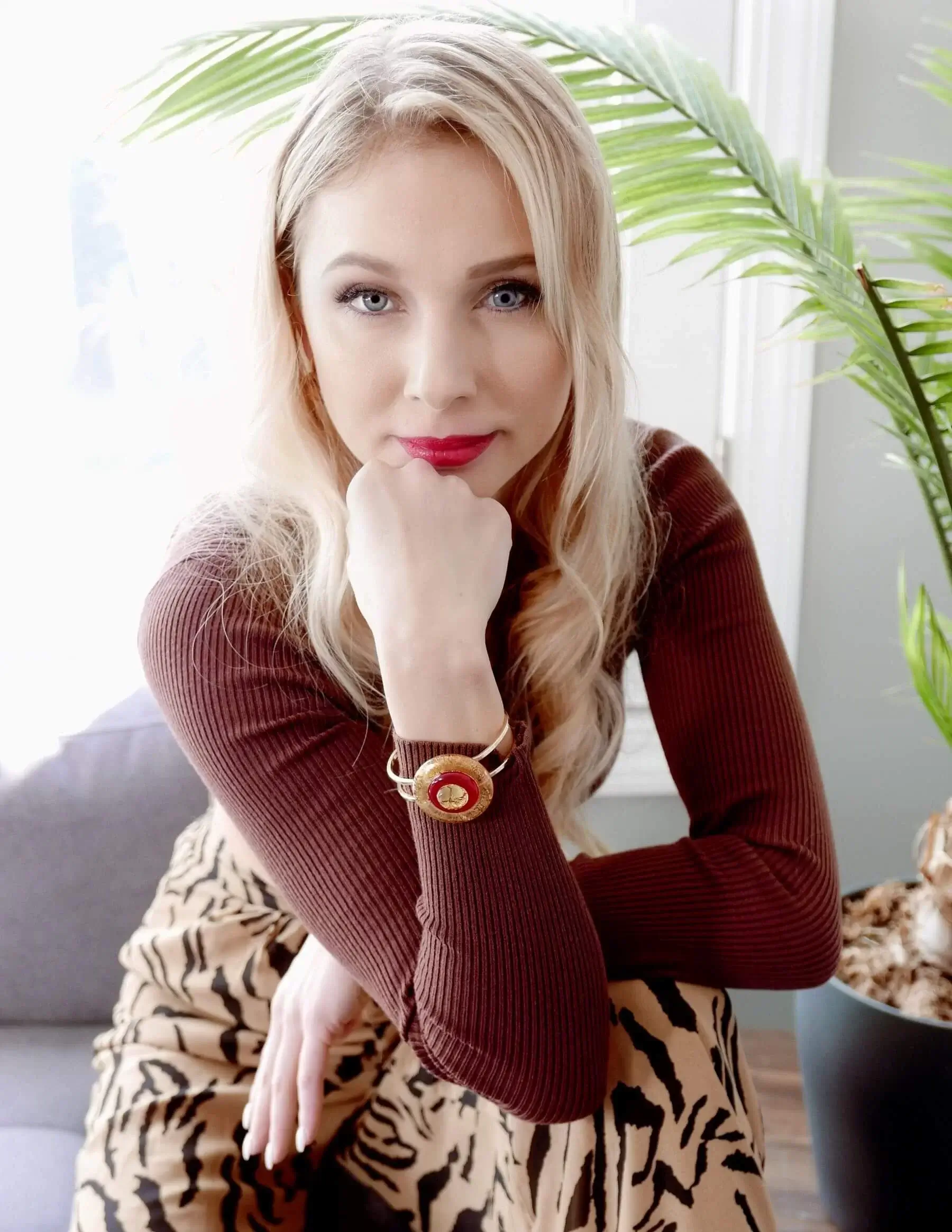model wearing golden and red Murano glass bracelet
