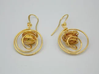 Swirling gold rhodium earrings with gold and red Murano bead