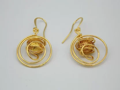 Swirling gold rhodium earrings with gold and red Murano bead