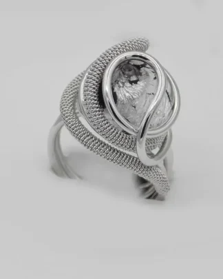 swirls of detailed wire wrapped silver tone metal create a dome ring with a silver and black Murano glass bead nickel free