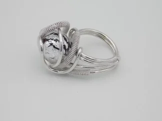 swirls of detailed wire wrapped silver tone metal create a dome ring with a silver and black Murano glass bead nickel free
