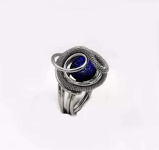 swirling silver tone rhodium ring with a mounted bllue Murano glass bead