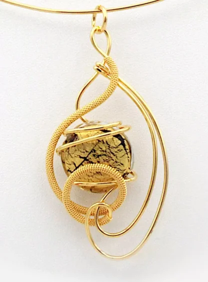arabesque gold pendant necklace with black gold glass-closeup