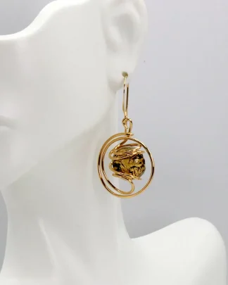 Swirling metal drop gold earring with a Murano gold and black speckled Murano glass bead