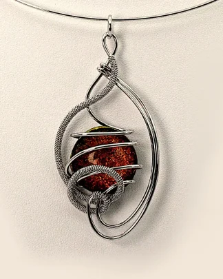 Arabesque shape silver pendant with a fiery bronze Murano glass bead close up