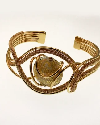 Golden serpentine shaped cuff bracelet with multi-strands of metal, wrapped wire and a gold Murano glas bead