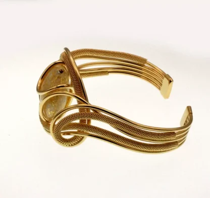 Serpentine shaped cuff bracelet with multi-strands wrapped wire and a gold Murano glass bead