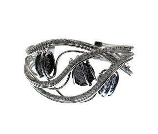 Cuff bracelet waves of silver with wire wrapping around frame holds three grey Murano glass beads
