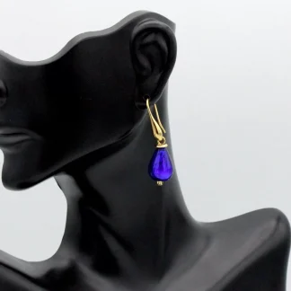 Cobalt Murano glass teardrop earring 1 1/2 inch teardrop shape in gold tone wires on model
