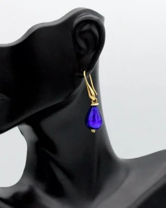 Cobalt Murano glass teardrop earring 1 1/2 inch teardrop shape in gold tone wires on model