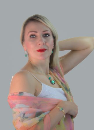 model wearing aqua and gold 20 inch pendant of Murano glass with seed beads