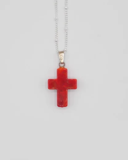 Small 3/4 inch coral Murano glass cross on a silver plated satellite chain