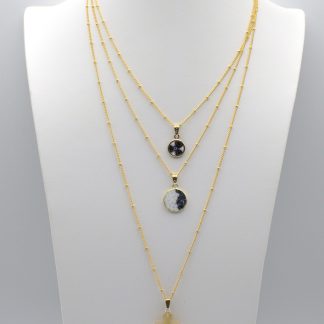 Layered two millefiori necklaces and one gold Murano cross on three separate gold plated layered necklaces