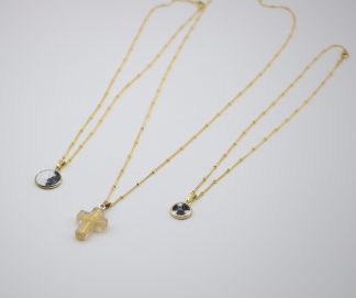 Set of three layered Murano necklaces, two millefiori and one Murano glass gold cross on three gold plated satellite necklaces