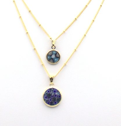 Two Murano millefiori small blue tone disc necklaces in gold casings on gold chains