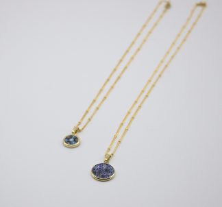 Flat view of two small Murano millefiori layered necklaces on gold chains
