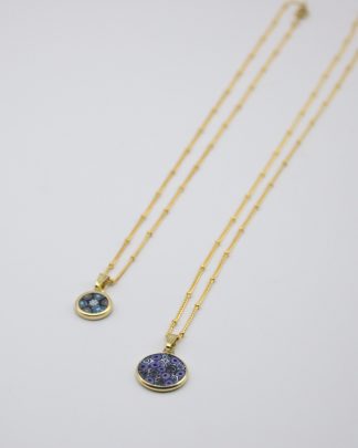 Flat view of two small Murano millefiori layered necklaces on gold chains