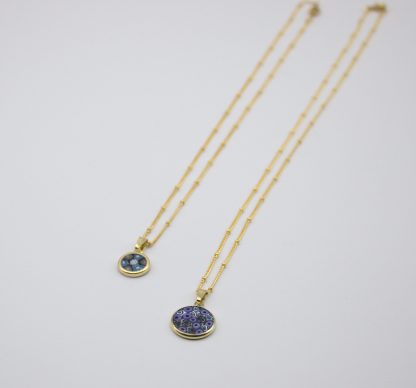 Flat view of two small Murano millefiori layered necklaces on gold chains