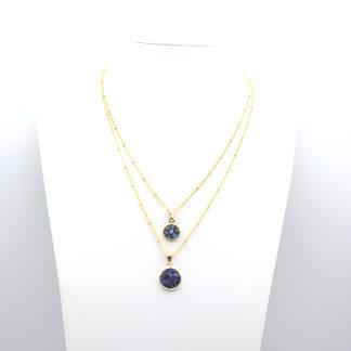 Two millefiori blue tone gold encased small millefiori pendants on gold chains layered