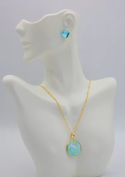 Turquoise Murano glass disc in gold on a gold detailed chain with earrings