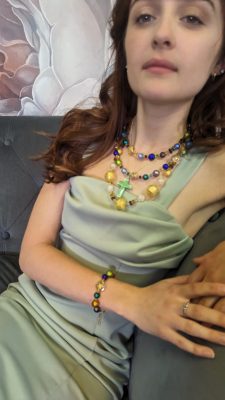 multiple Murano necklaces gold and colors on model 