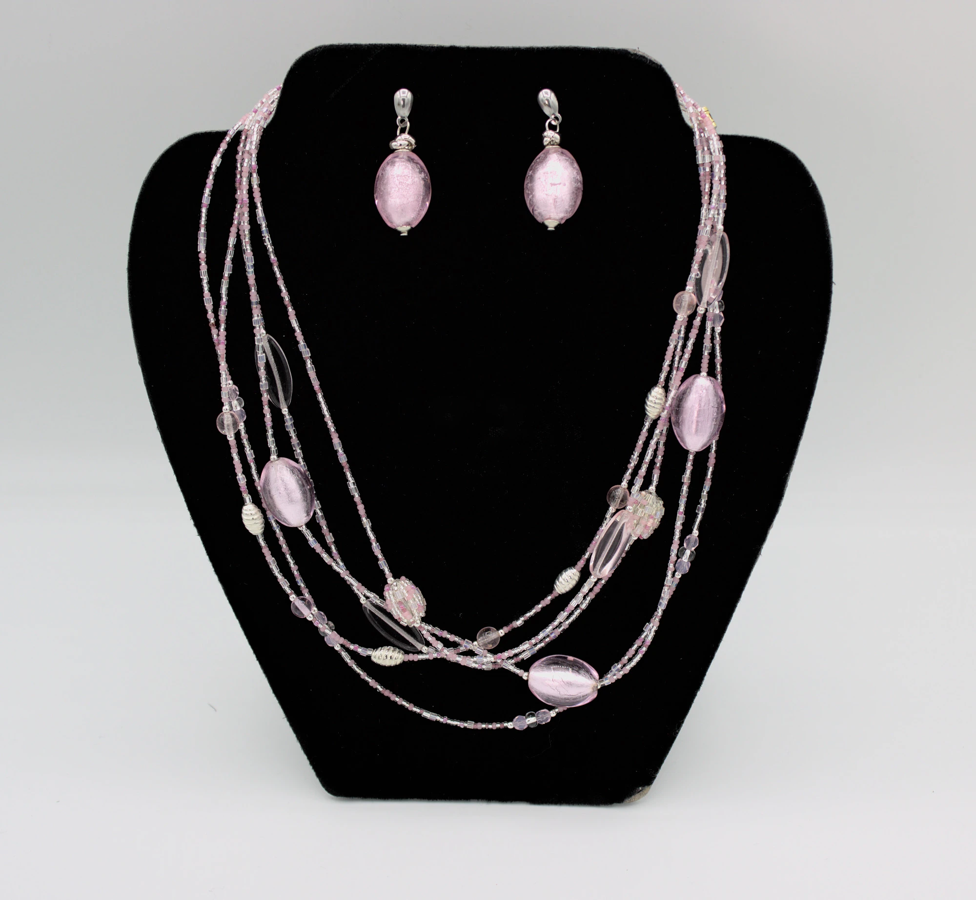 Lustrous pink multi strand graduated beaded necklace with matching earrings