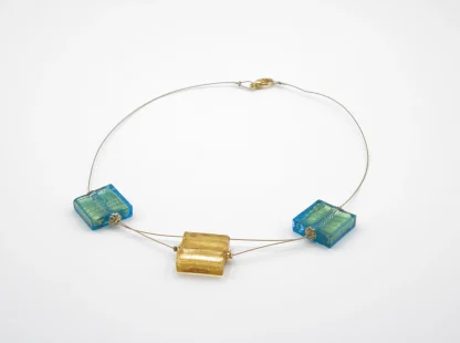 Murano glass cube necklace 2 aqua color cubes and one dropped gold cube on a titanium necklace