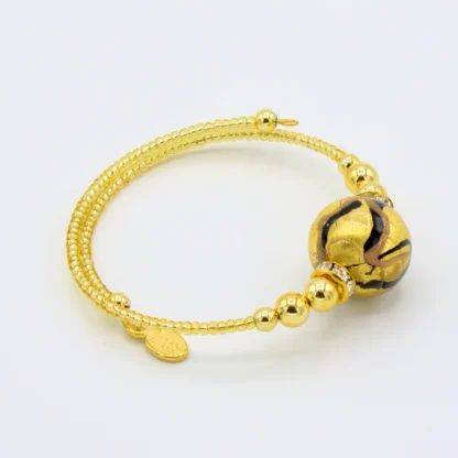 Gold wrap bracelet with gold seed beads and one large round bead with blank marking