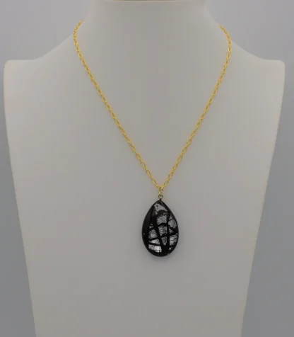 Murano black patterned glass on silver teardrop pendant on a 16 inch gold chain