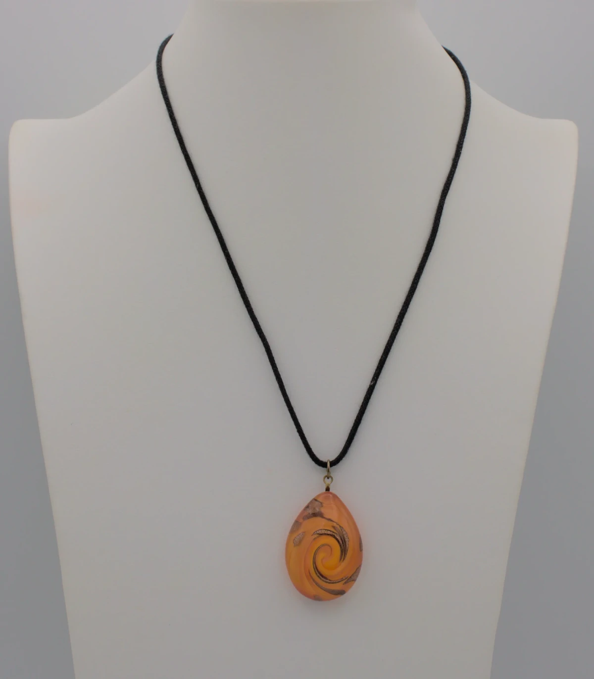 Murano glass orange teardrop pendant with copper swirls on black cotton cord