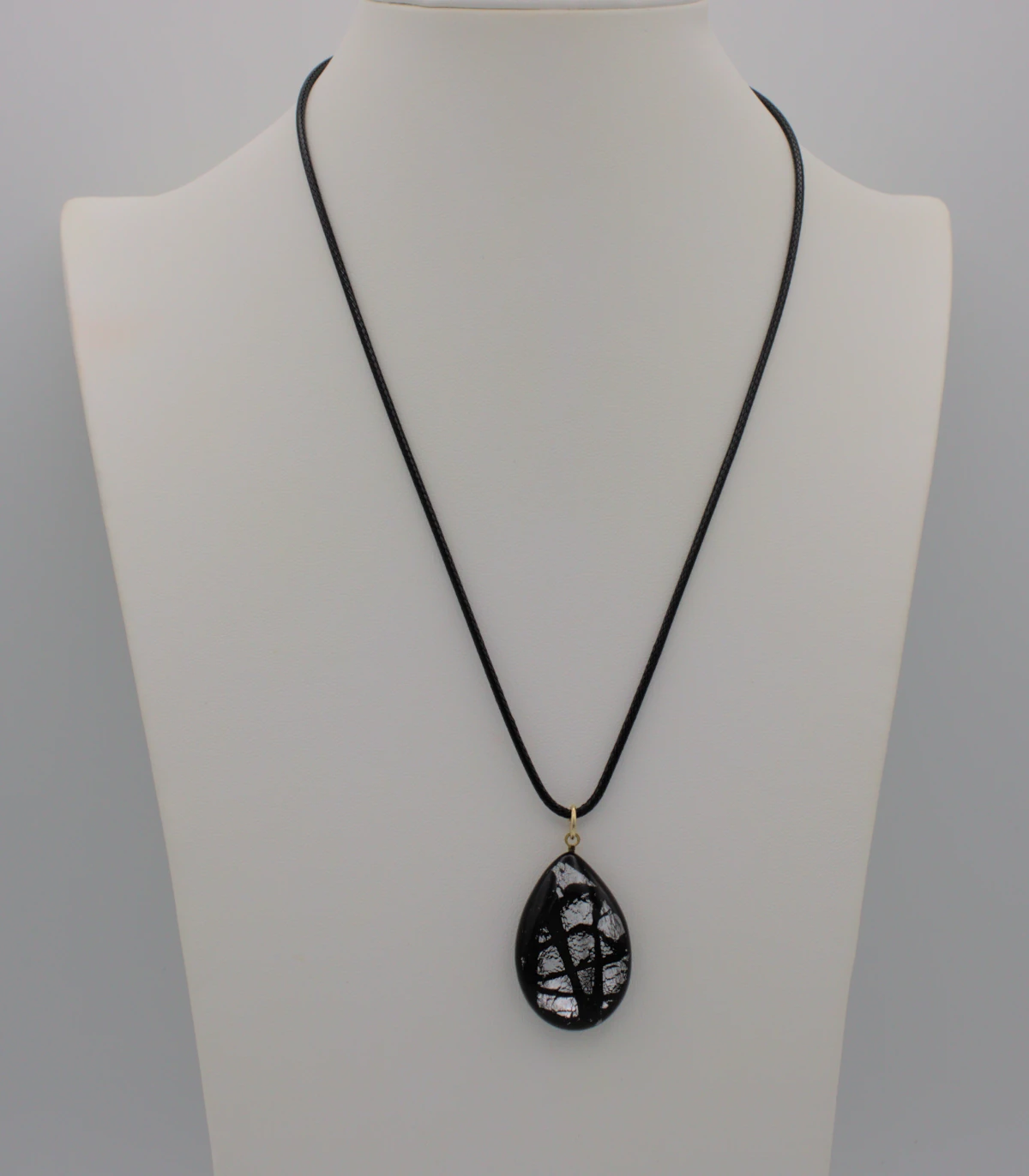 Murano black patterned glass on silver teardrop pendant on a black cotton cord