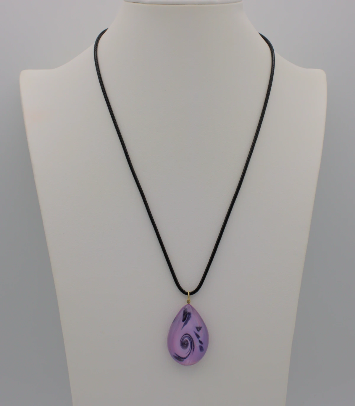 Murano glass purple scroll teardrop pendant on a black cotton cord
