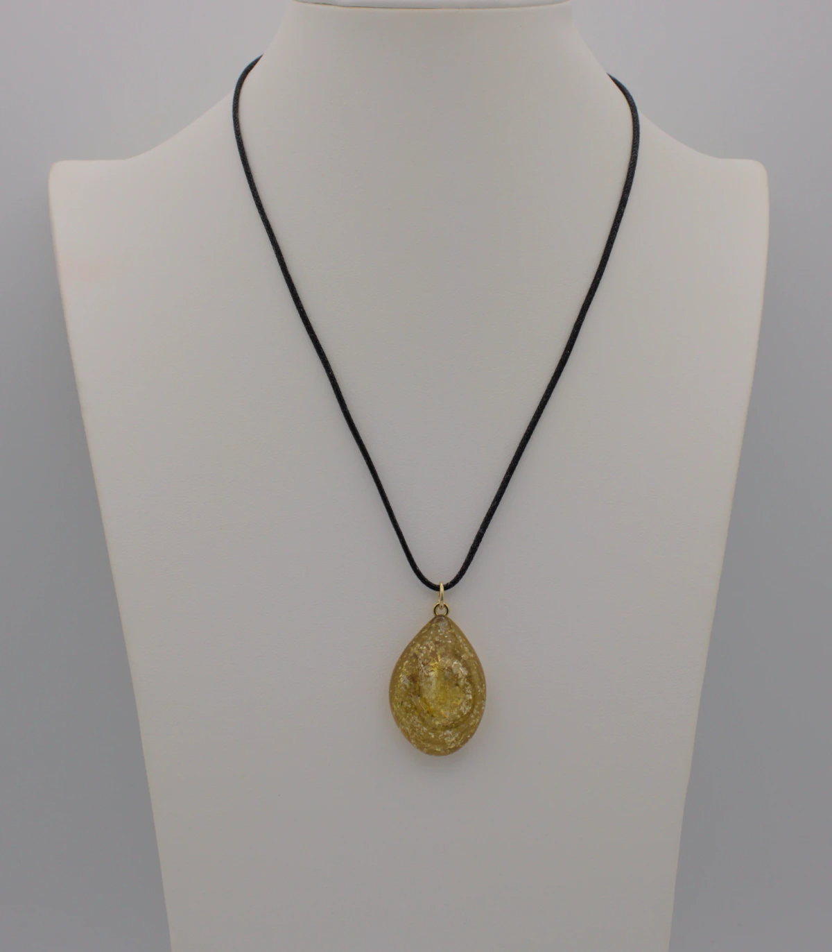 Golden tones swirls of Murano glass gold infused pendant on a black cotton cord