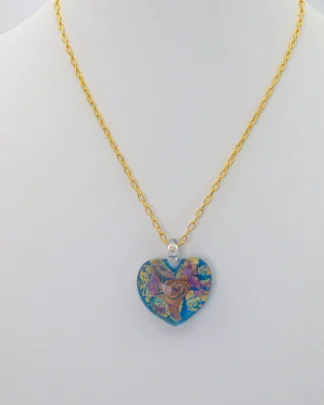 Swirls of gold and copper on a turquoise Murano glass heart 1 inch long, 1 inch wide on a 16 inch gold plated chain