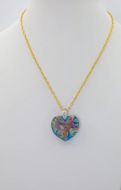 Swirls of gold and copper on a turquoise Murano glass heart 1 inch long, 1 inch wide on a 16 inch gold plated chain