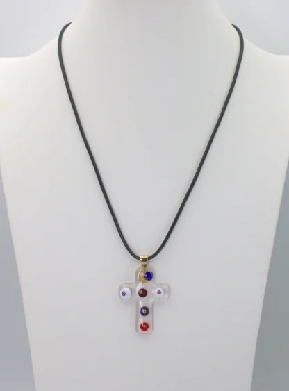 Clear Murano glass cross pendant with colorful millefiori decoration on a cotton cord