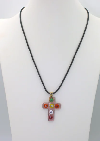 Clear pink Murano glass cross pendant with colorful millefiori decoration on a cotton cord