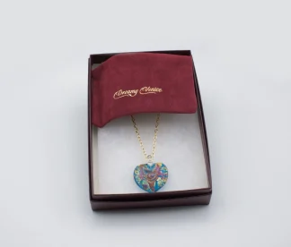 Swirls of gold and copper on a turquoise Murano glass heart 1 inch long, 1 inch wide on an 18 inch silk cord