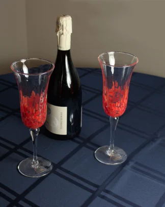 murano champagne flutes on a table with a bottle of champagne