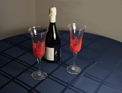 murano champagne flutes on a table with a bottle of champagne