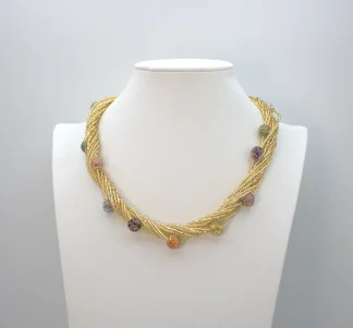 Gold multi-strand Murano seed bead necklace with lampworked beads interspersed.