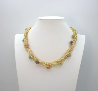 Gold multi-strand Murano seed bead necklace with lampworked beads interspersed.