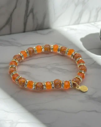 Orange Murano stretch bracelet with mini bling and a gold charm