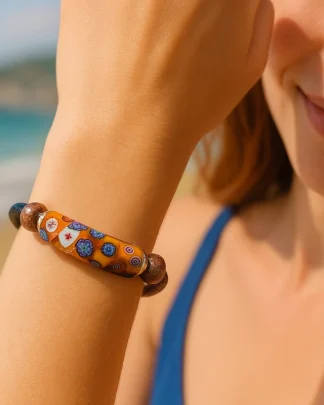 Orange millefiori wrap bracelet with leather snap wrist bands on model