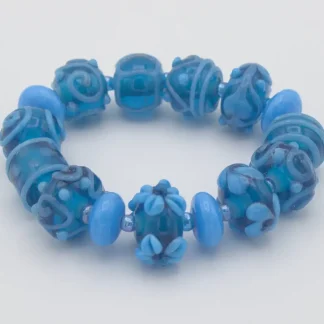 Stretch bracelet turquoise Murano glass hand made extra fancy beads with floral and other patterns on hand blown beads