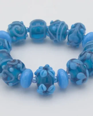 Stretch bracelet turquoise Murano glass hand made extra fancy beads with floral and other patterns on hand blown beads